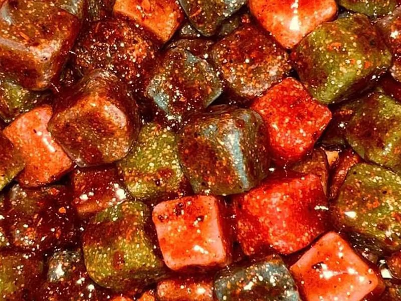 Chamoy candy, with a bright red spicy sauce on the outside, is sweet and sour
