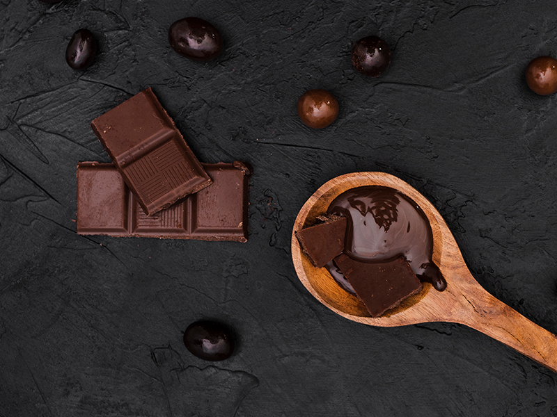 Dark chocolate bars stacked, representing a healthy snack option.