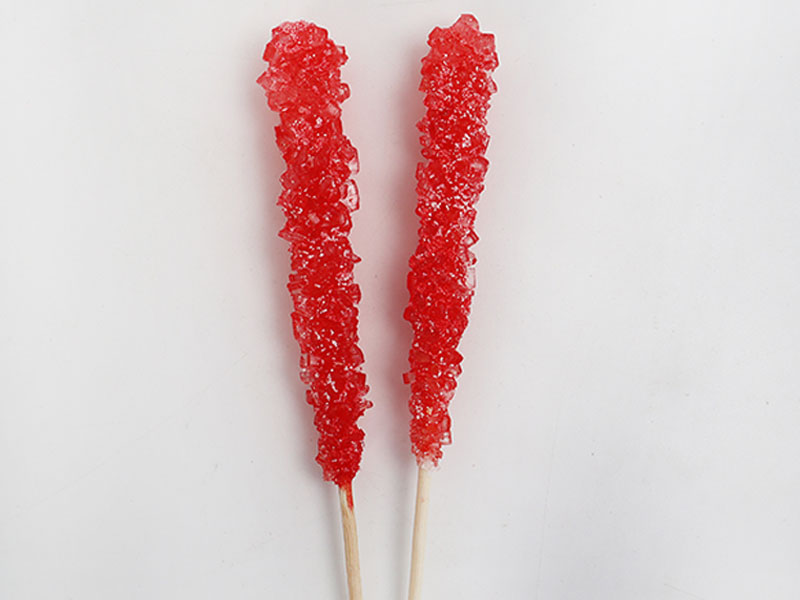Rock candy crystals forming on sticks during candy production process